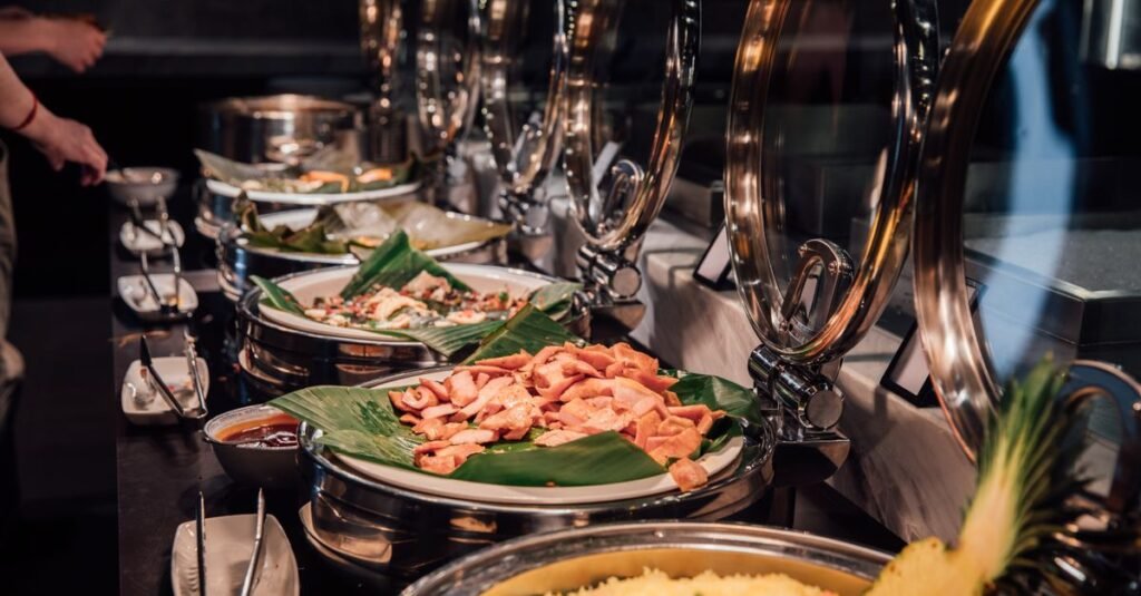 Elegant buffet setup featuring tropical dishes on banana leaves, ideal for event catering inspiration.
